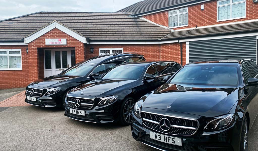 The fleet of cars are parked outside of Harpin's Funeral Service Wakefield branch.