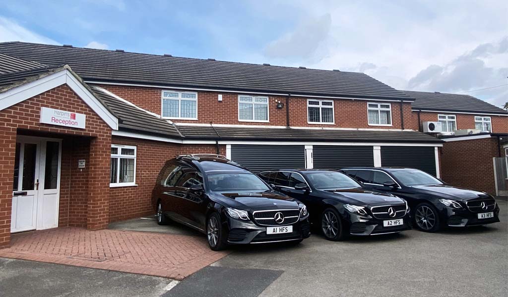 The fleet of cars are parked outside of Harpin's Funeral Service Wakefield branch.